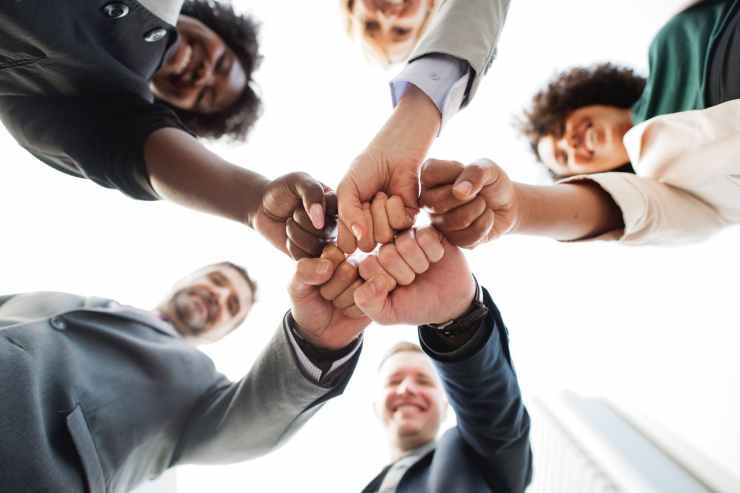 photo of people doing fist bump